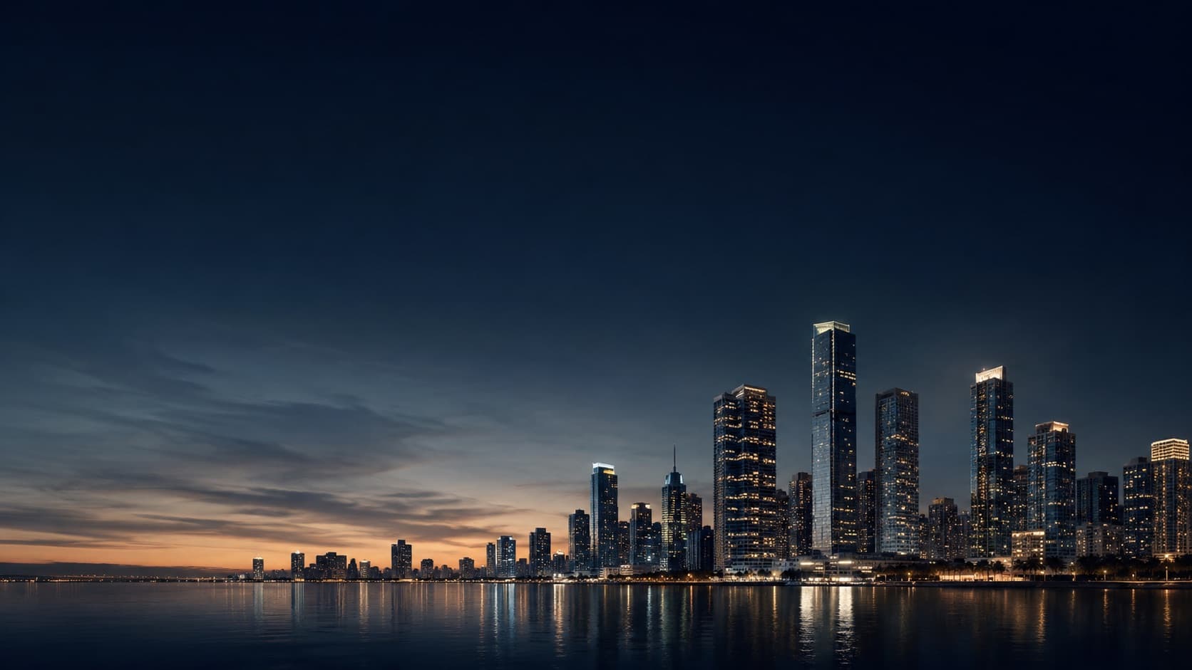 A waterfront city skyline lit at dusk, reflected in calm water